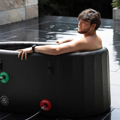 Garvnive Black PVC Ice Bath Tub with an air-filled insulation layer; a man is undergoing cold therapy recovery outdoors.